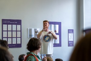 Man standing in brennan library using sign language