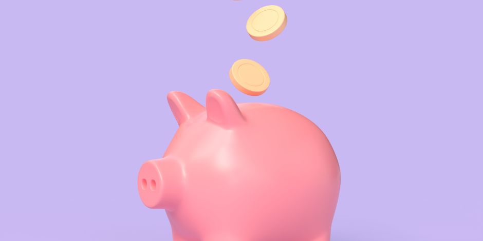pink piggy bank on lilac background