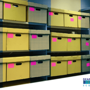 Deaf History Scotland archive boxes overlaid with yellow and blue tartan.
