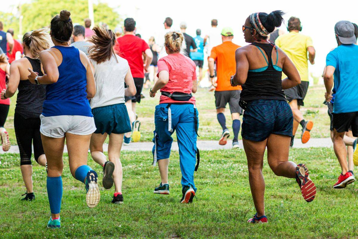 A group of people running in a park.