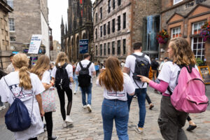 A group of people walking down the royal mile in Edinburgh
