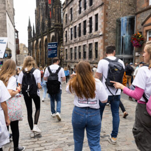 A group of people walking down the royal mile in Edinburgh