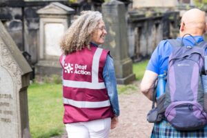 A tour guide wearing a Deaf Action vest.