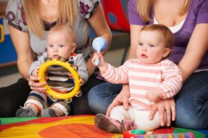 young children holding musical instruments.