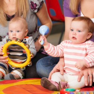 young children holding musical instruments.